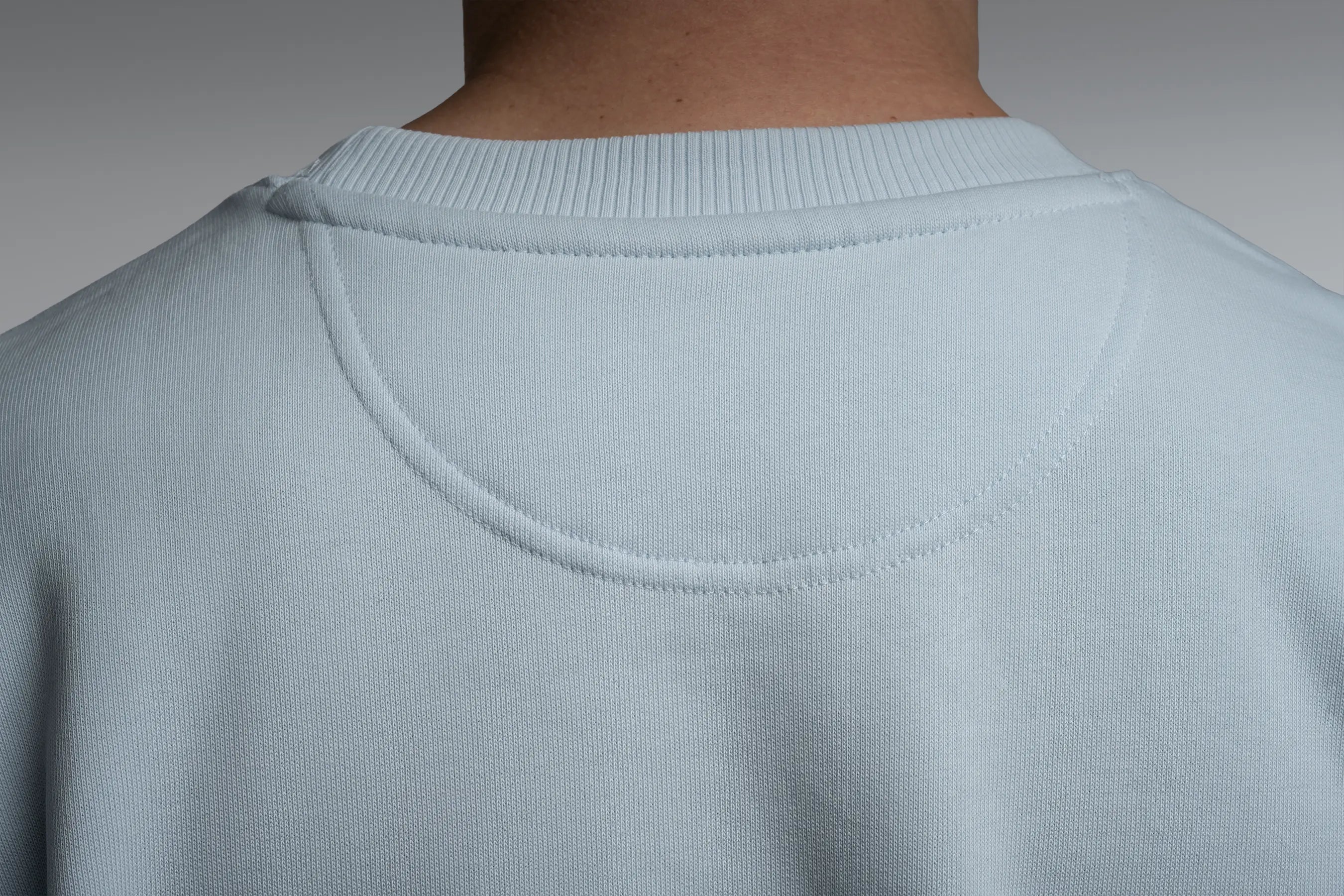 Back view close-up of the premium fabric of the oversized sweatshirt in Blue Ice.