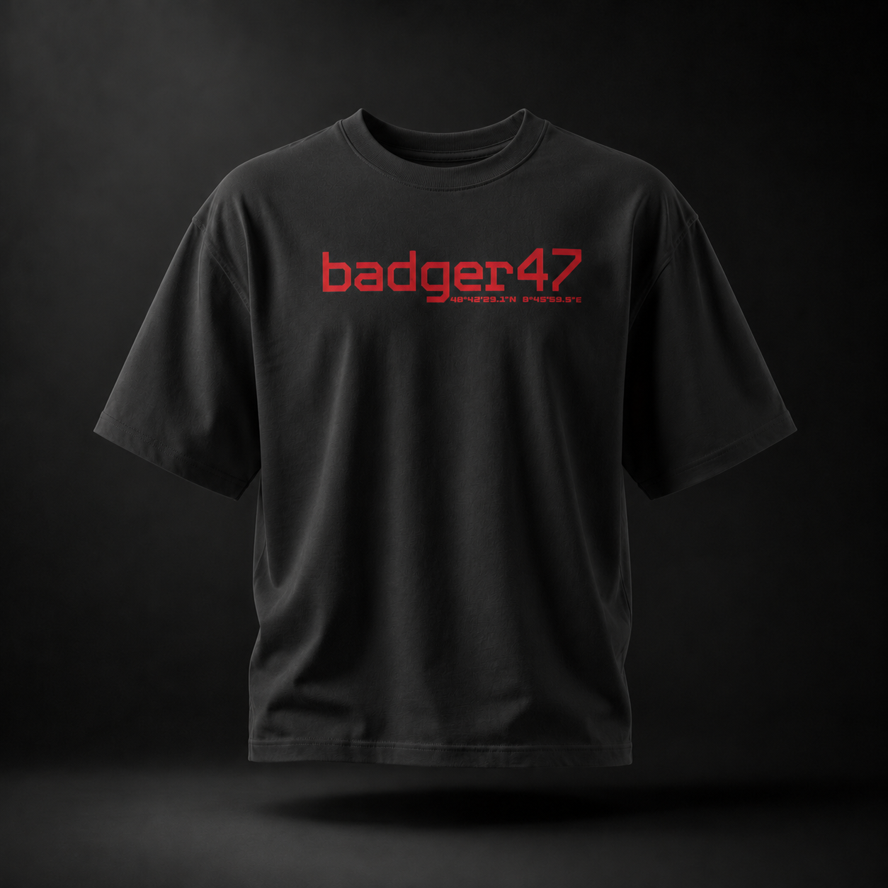 Schwarzes Badger 47 Strive Oversized T-Shirt mit rotem Logo-Print auf der Vorderseite und natürlichem Faltenwurf
