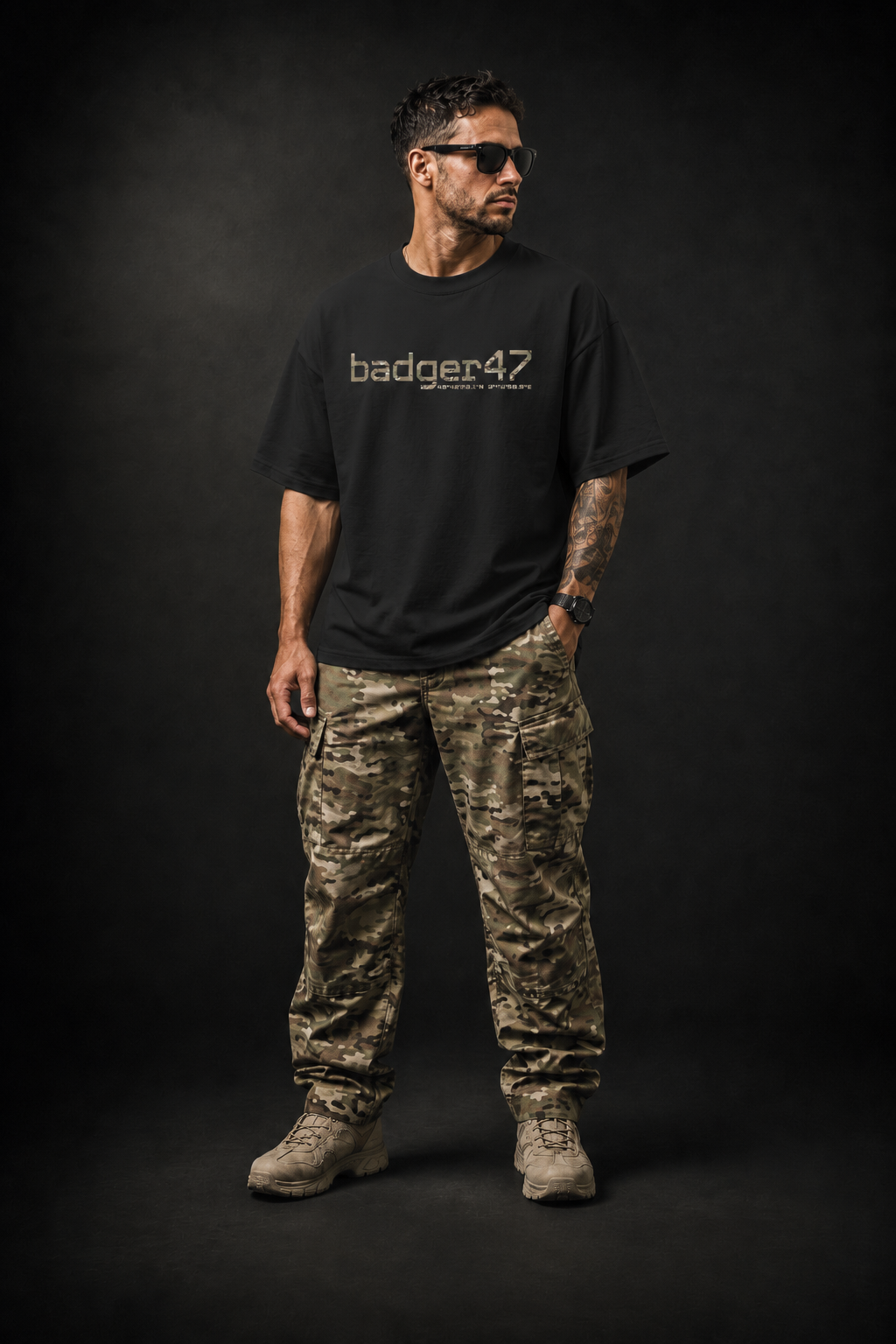 BADGER47 FIELD Organic Oversize T-Shirt in Black mit Multicam-Logo, getragen mit Multicam-Cargohose im dunklen Studio
